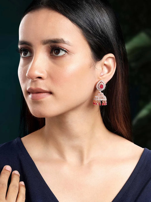 Luxurious Ruby & CZ Dangle Jhumki. A pair of Rose gold plating jhumka earrings with Cubic Zirconia Diamonds & Red rubies. Best for your elegant ethnic looks.
