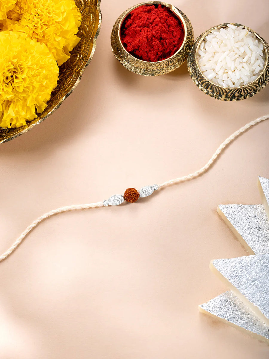 Close-up of 925 Silver Thread Rakhi with Beads featuring maroon - cream thread, nan work, and rhodium plating – ideal for Raksha Bandhan | Peora
