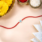 Close-up of 925 Silver Thread Rakhi with Evil Eye featuring red thread, cubic zirconia work, and rhodium plating – ideal for Raksha Bandhan | Peora
