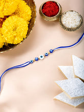 Close-up of Evil Eye Sterling Silver Thread Rakhi featuring blue & white thread, nan work, and rhodium plating – ideal for Raksha Bandhan | Peora
