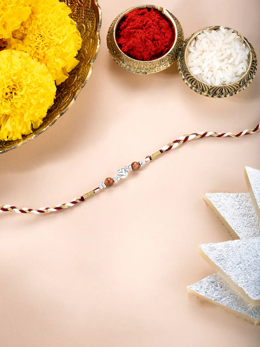Close-up of Sterling Rakhi with Shining Beads featuring red - silver thread, nan work, and rhodium plating – ideal for Raksha Bandhan | Peora
