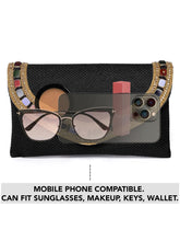 Black clutch bag named Woven Party Clutch with Stone Embellish, featuring faux emerald detailing and soft fabric texture | Peora
