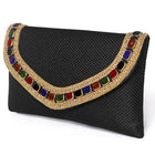 Black clutch bag named Woven Party Clutch with Stone Embellish, featuring faux emerald detailing and soft fabric texture | Peora
