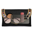 Black clutch bag named Woven Party Clutch with Stone Embellish, featuring faux emerald detailing and soft fabric texture | Peora
