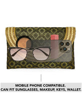 Blue clutch bag named Twilight Gleam Foldover Clutch, featuring pearl detailing and soft fabric texture | Peora
