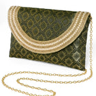 Blue clutch bag named Twilight Gleam Foldover Clutch, featuring pearl detailing and soft fabric texture | Peora
