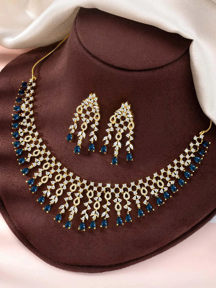 Elegant Shine Sparkling CZ Necklace Set by Peora. Gold-plated necklace with CZ white & blue stones, along with matching earrings.