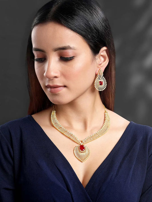 Sparkling Royal Ruby CZ Necklace Set by Peora. Gold-plated necklace set with a geometric pattern and red-colored stones and earrings.