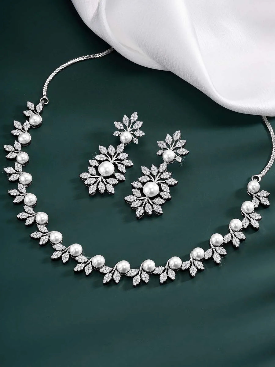 Lustrous Luxe CZ Stud Necklace Set. Silver-plated with white cubic zirconia stones, pearls, and floral design, with matching earrings.