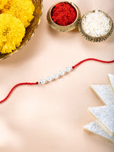 Close-up of Pearl Charm Rakhi in Sterling Silver featuring red - white thread, pearl work, and rhodium plating – ideal for Raksha Bandhan | Peora
