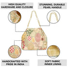 Cream potli bag named Royal Charm Handcrafted Embroidery Potli, featuring artificial beads detailing and soft fabric texture | Peora
