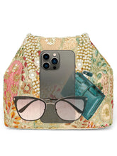 Cream potli bag named Royal Charm Handcrafted Embroidery Potli, featuring artificial beads detailing and soft fabric texture | Peora
