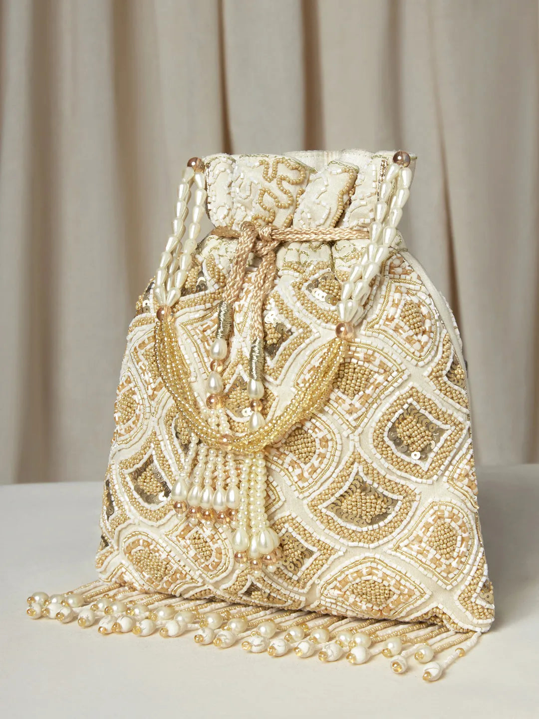 Cream potli bag named Heavy Zari Sequin Wedding Potli, featuring artificial beads detailing and soft fabric texture | Peora
