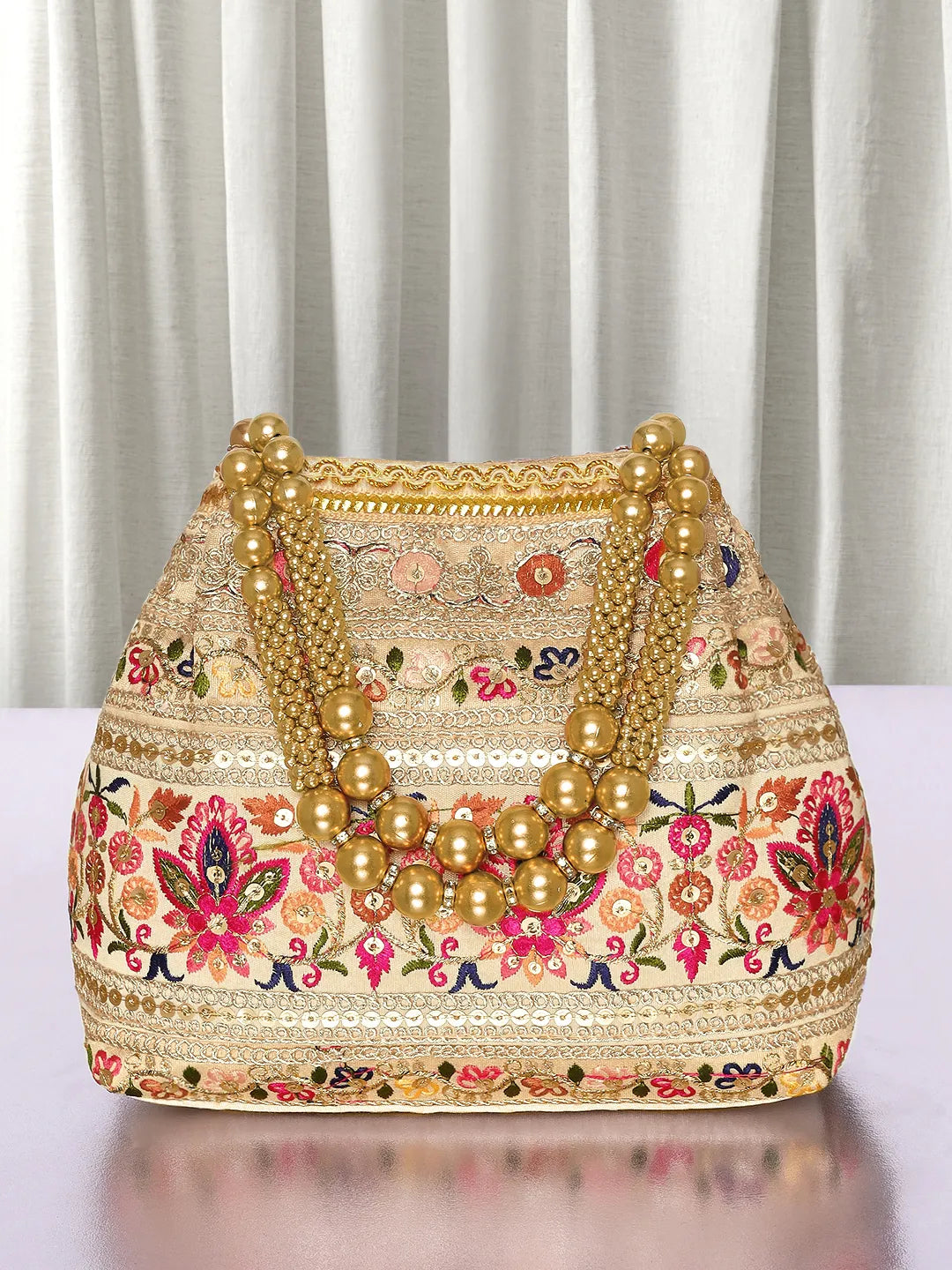 Cream potli bag named Thread Embroidery Potli with Sequin Motif, featuring artificial beads detailing and soft fabric texture | Peora
