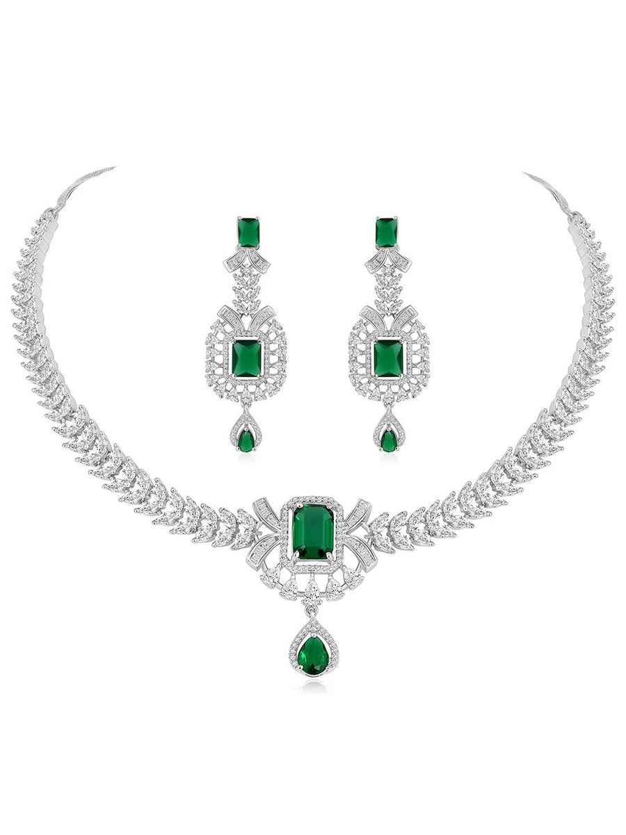 Emerald Elegance Crystal CZ Necklace Set. A silver-colored necklace and earring set with green emerald stones and clear cubic zirconia accents.