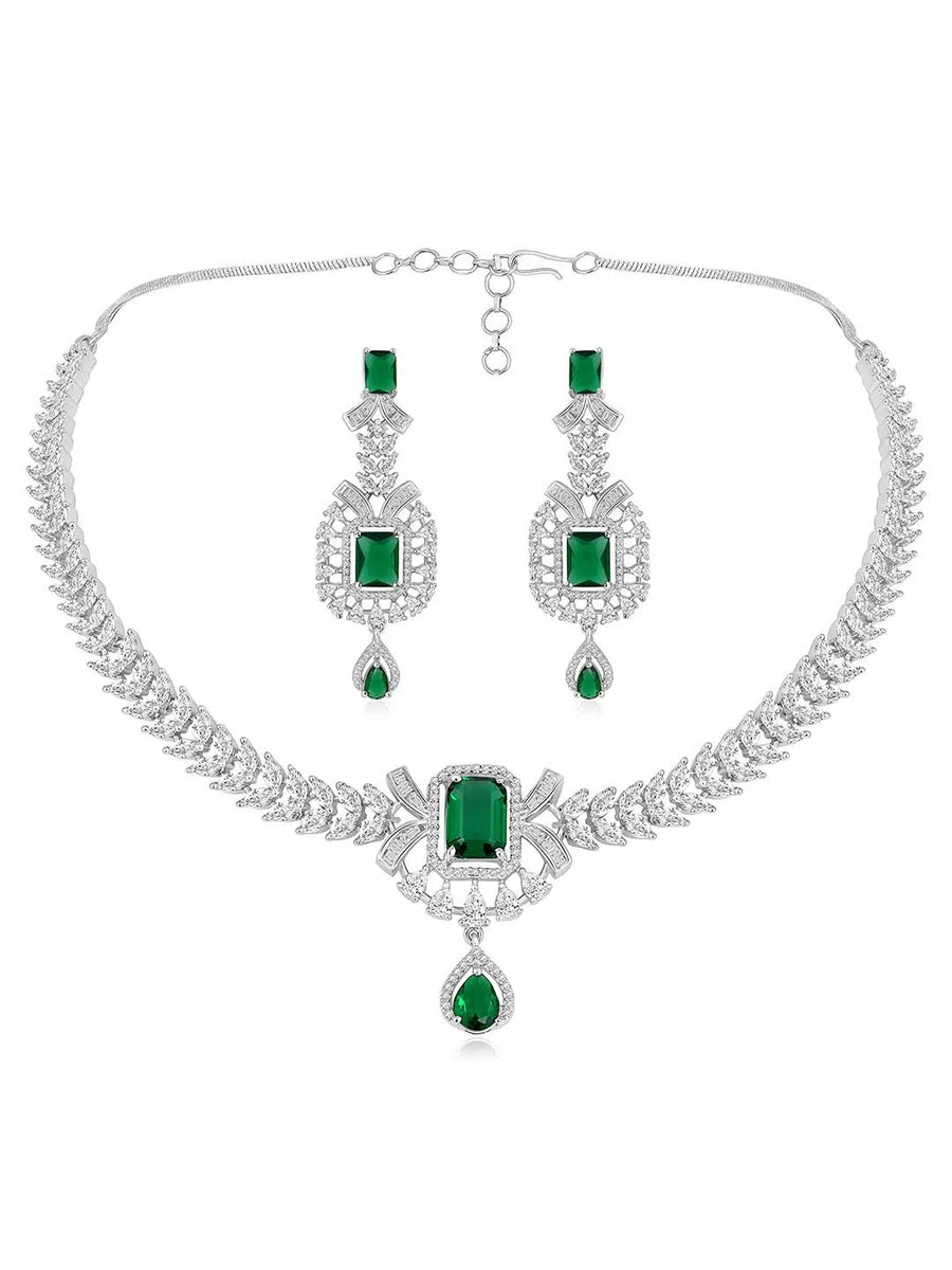Emerald Elegance Crystal CZ Necklace Set. A silver-colored necklace and earring set with green emerald stones and clear cubic zirconia accents.