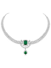 Emerald Elegance Crystal CZ Necklace Set. A silver-colored necklace and earring set with green emerald stones and clear cubic zirconia accents.