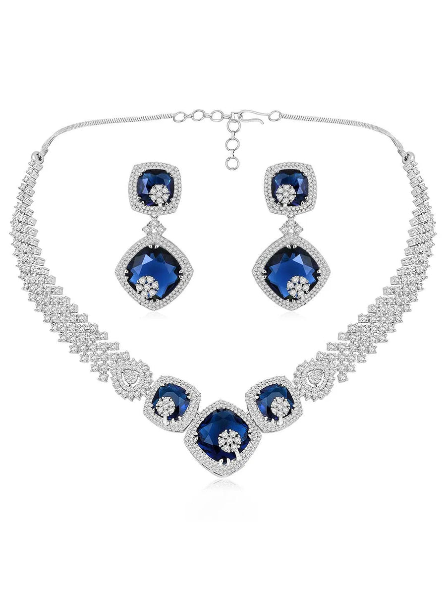 Exquisite CZ Necklace Sets Collection. A silver-colored necklace and earring set with blue and white cubic zirconia stones.