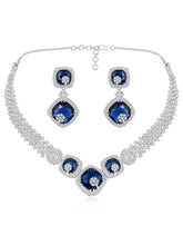 Exquisite CZ Necklace Sets Collection. A silver-colored necklace and earring set with blue and white cubic zirconia stones.
