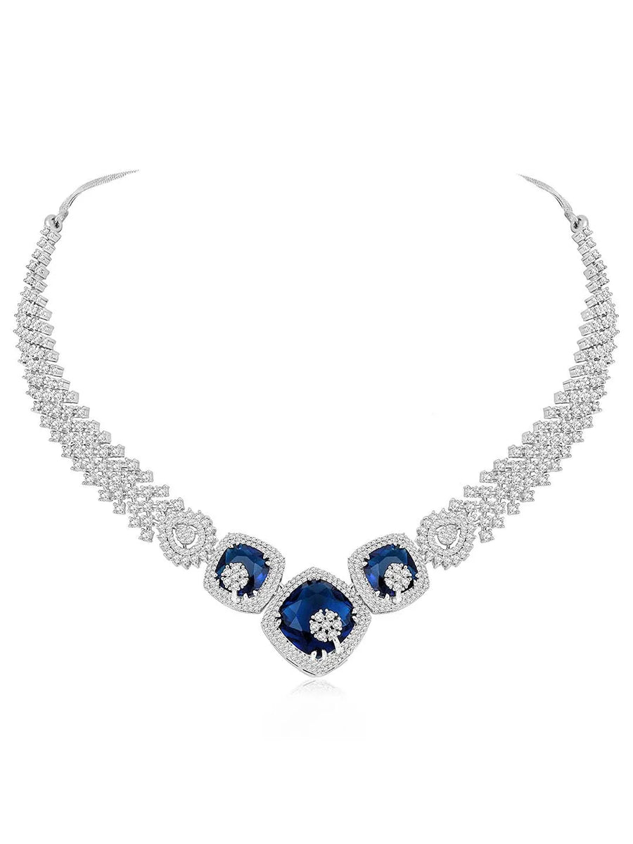 Exquisite CZ Necklace Sets Collection. A silver-colored necklace and earring set with blue and white cubic zirconia stones.