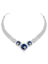 Exquisite CZ Necklace Sets Collection. A silver-colored necklace and earring set with blue and white cubic zirconia stones.