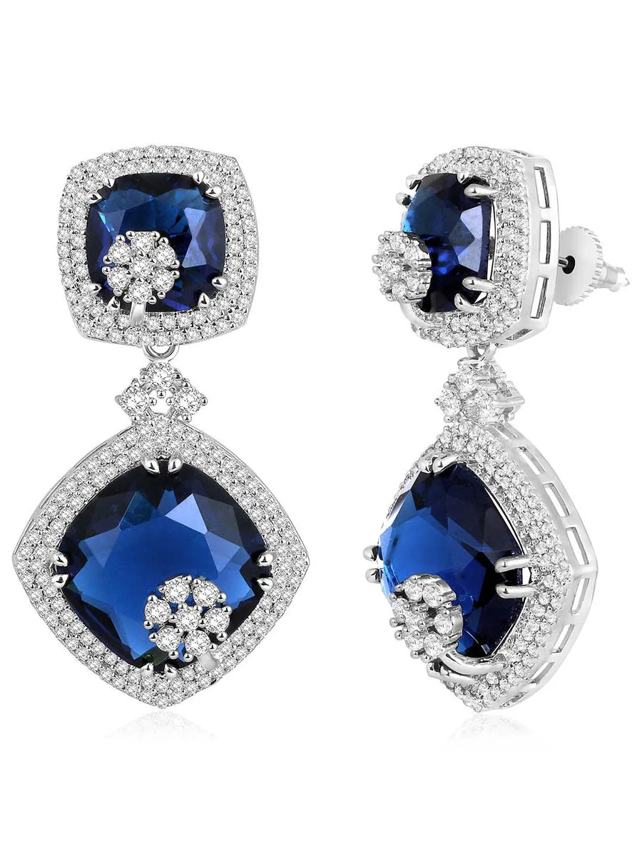 Exquisite CZ Necklace Sets Collection. A silver-colored necklace and earring set with blue and white cubic zirconia stones.