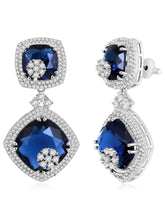 Exquisite CZ Necklace Sets Collection. A silver-colored necklace and earring set with blue and white cubic zirconia stones.