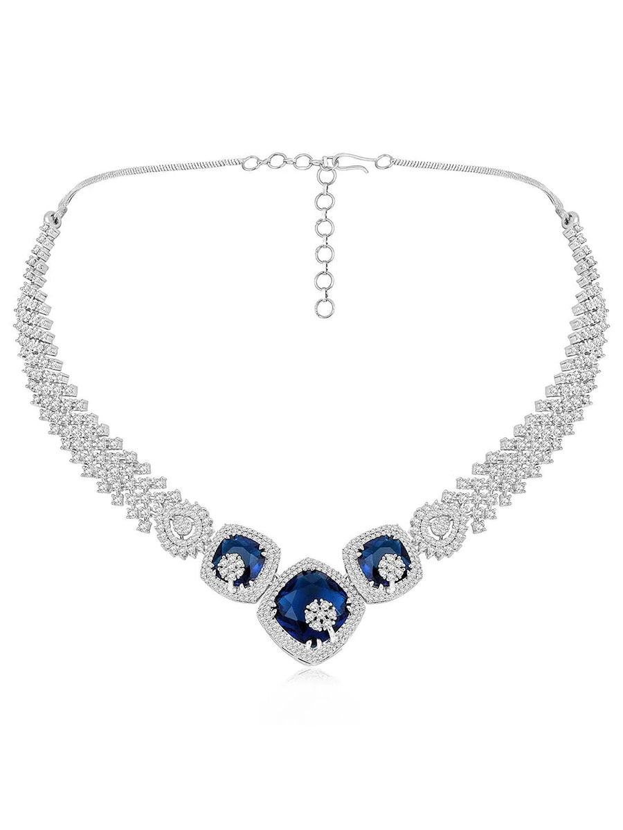 Exquisite CZ Necklace Sets Collection. A silver-colored necklace and earring set with blue and white cubic zirconia stones.