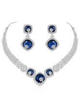 Exquisite CZ Necklace Sets Collection. A silver-colored necklace and earring set with blue and white cubic zirconia stones.