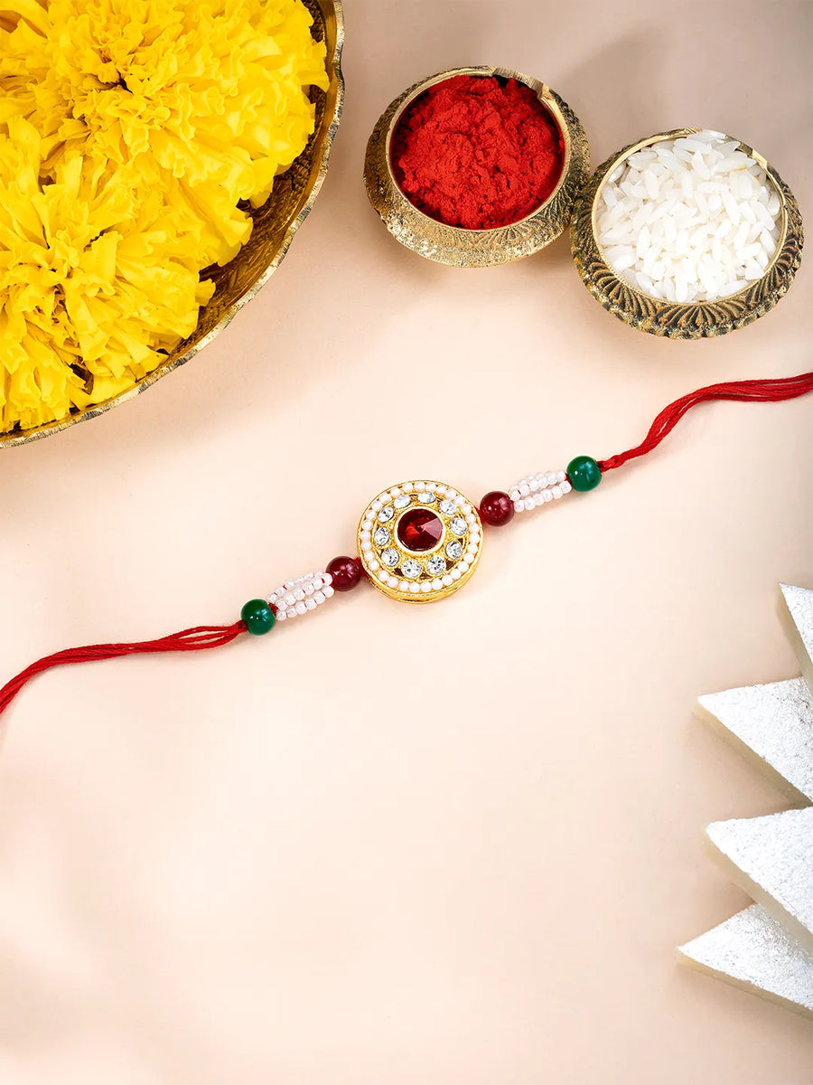Close-up of Chakra Inspired Crystal & Beads Rakhi with red thread, adorned with crystals & beads and finished in gold plating | Peora
