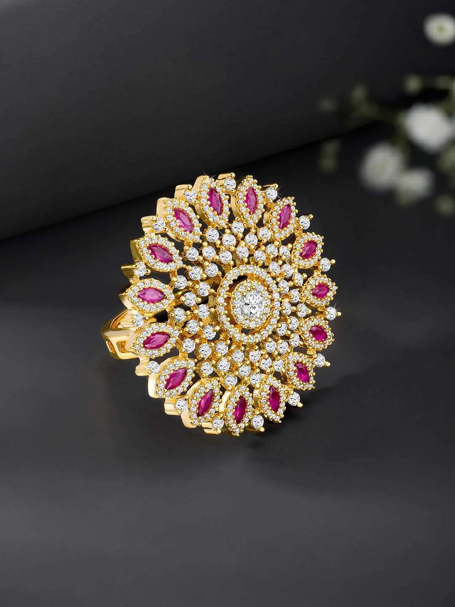 Bold Radiant Statement CZ Ring by Peora. Gold-Plated Adjustable ring with cubic zirconia in a radiant pattern, central larger crystal surrounded by smaller crystals in red.