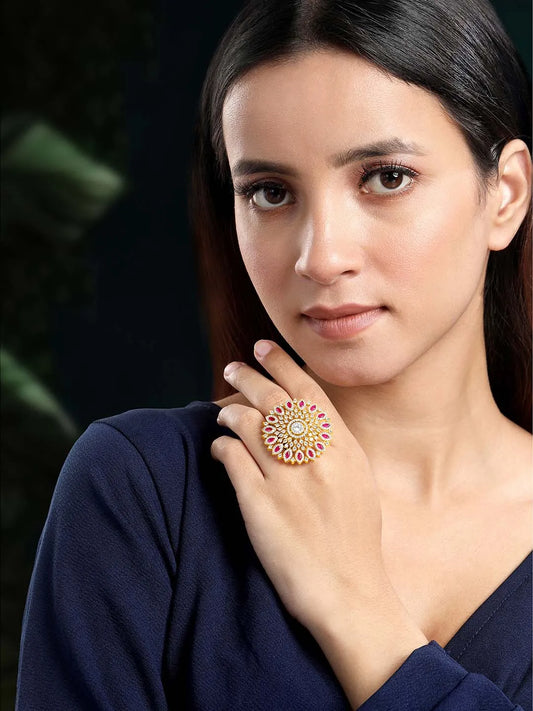 Bold Radiant Statement CZ Ring by Peora. Gold-Plated Adjustable ring with cubic zirconia in a radiant pattern, central larger crystal surrounded by smaller crystals in red.