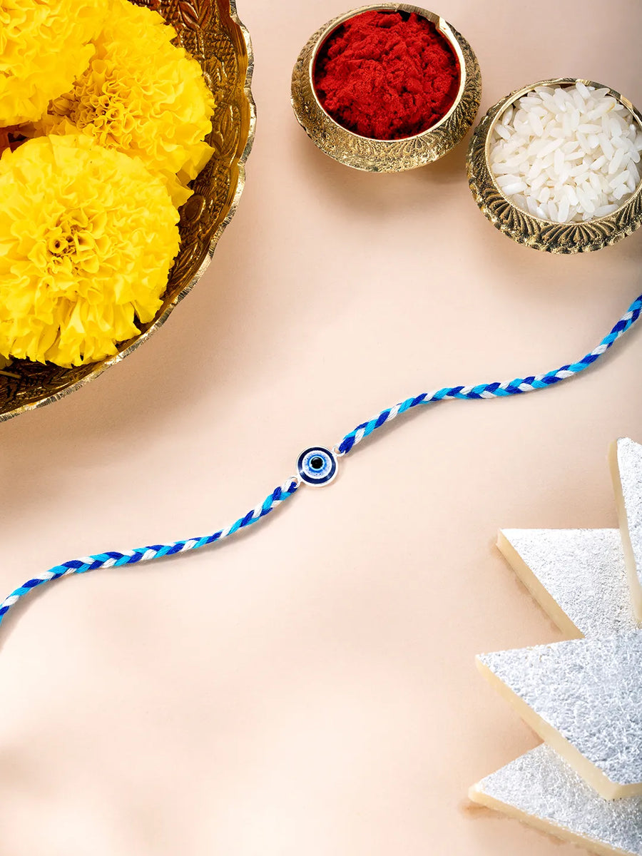 Close-up of Sterling Rakhi with Evil Eye Bead featuring blue & white thread, nan work, and rhodium plating – ideal for Raksha Bandhan | Peora
