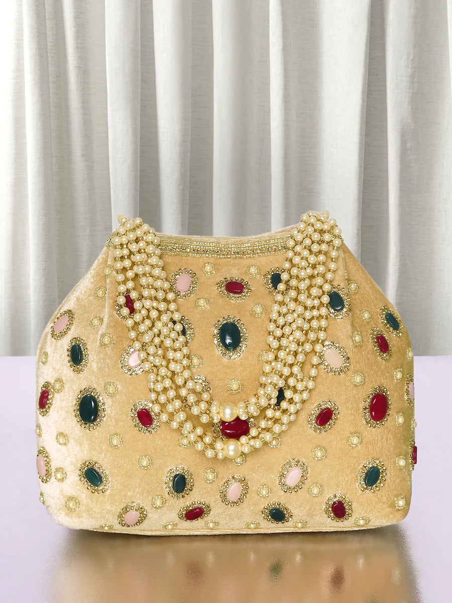 Gold potli bag named Embellished Ethnic Potli with Pearls, featuring faux emerald detailing and soft fabric texture | Peora
