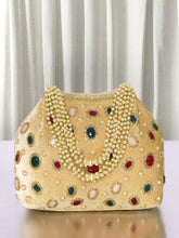 Gold potli bag named Embellished Ethnic Potli with Pearls, featuring faux emerald detailing and soft fabric texture | Peora
