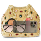 Gold potli bag named Embellished Ethnic Potli with Pearls, featuring faux emerald detailing and soft fabric texture | Peora
