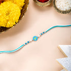 Close-up of Bloom Inspired Sterling Silver Rakhi featuring sky blue & white thread, beads work, and rhodium plating – ideal for Raksha Bandhan | Peora
