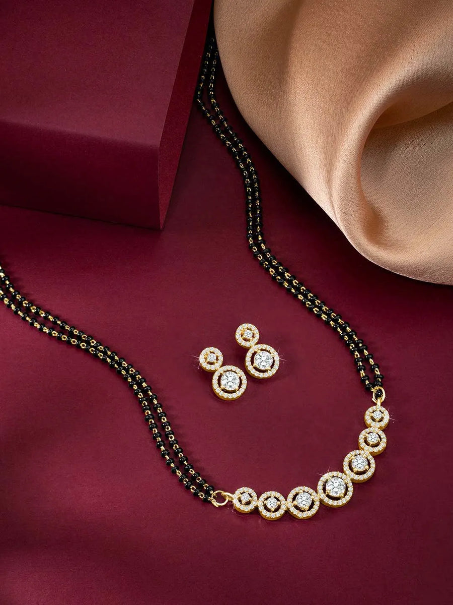Luxurious Gleaming CZ Mangalsutra Set. Mangalsutra and matching earrings with cubic zirconia stones along with gold plating.