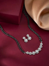 Luxurious Gleaming CZ Mangalsutra Set. Mangalsutra and matching earrings with cubic zirconia stones along with silver plating.
