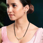 CZ Studded Traditional Mangalsutra Set. A traditional mangalsutra set with black beads and gold-color plating, zirconia stones, & matching earrings.