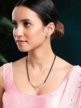 CZ Studded Traditional Mangalsutra Set. A traditional mangalsutra set with black beads and gold-color plating, zirconia stones, & matching earrings.