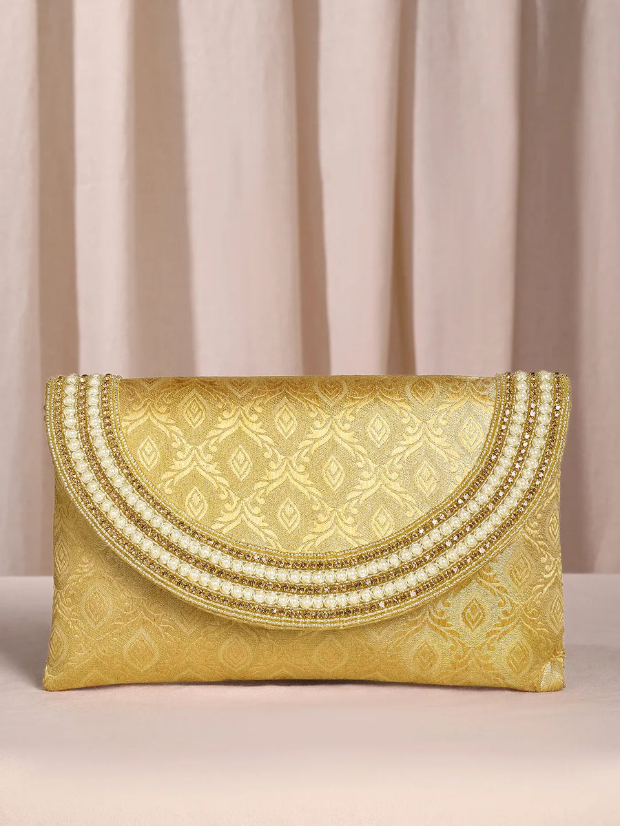 Gold clutch bag named Twilight Gleam Foldover Clutch, featuring pearl detailing and soft fabric texture | Peora
