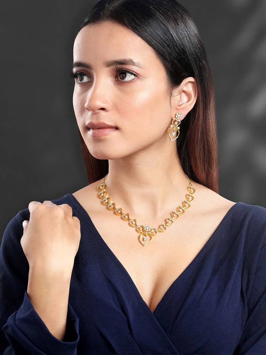 Golden Glamour Dangler CZ Necklace Set. Gold-plated necklace and earrings set with heart shapes and cubic zirconia stones.
