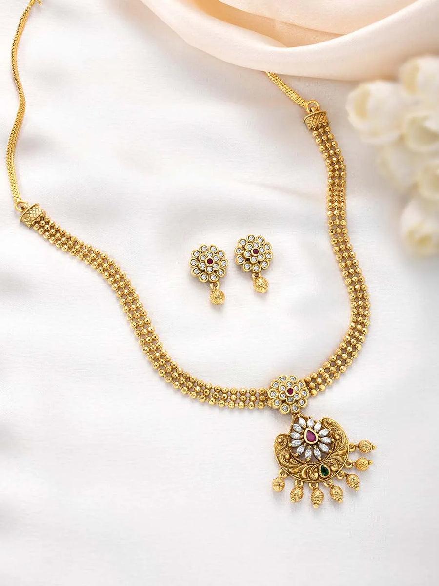 Luxurious Golden Glamour Necklace Set. Necklace set with floral patterns and pink, green & white stones.