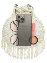 White potli bag named Handcrafted Pearl Potli Styles, featuring pearl detailing and soft fabric texture | Peora
