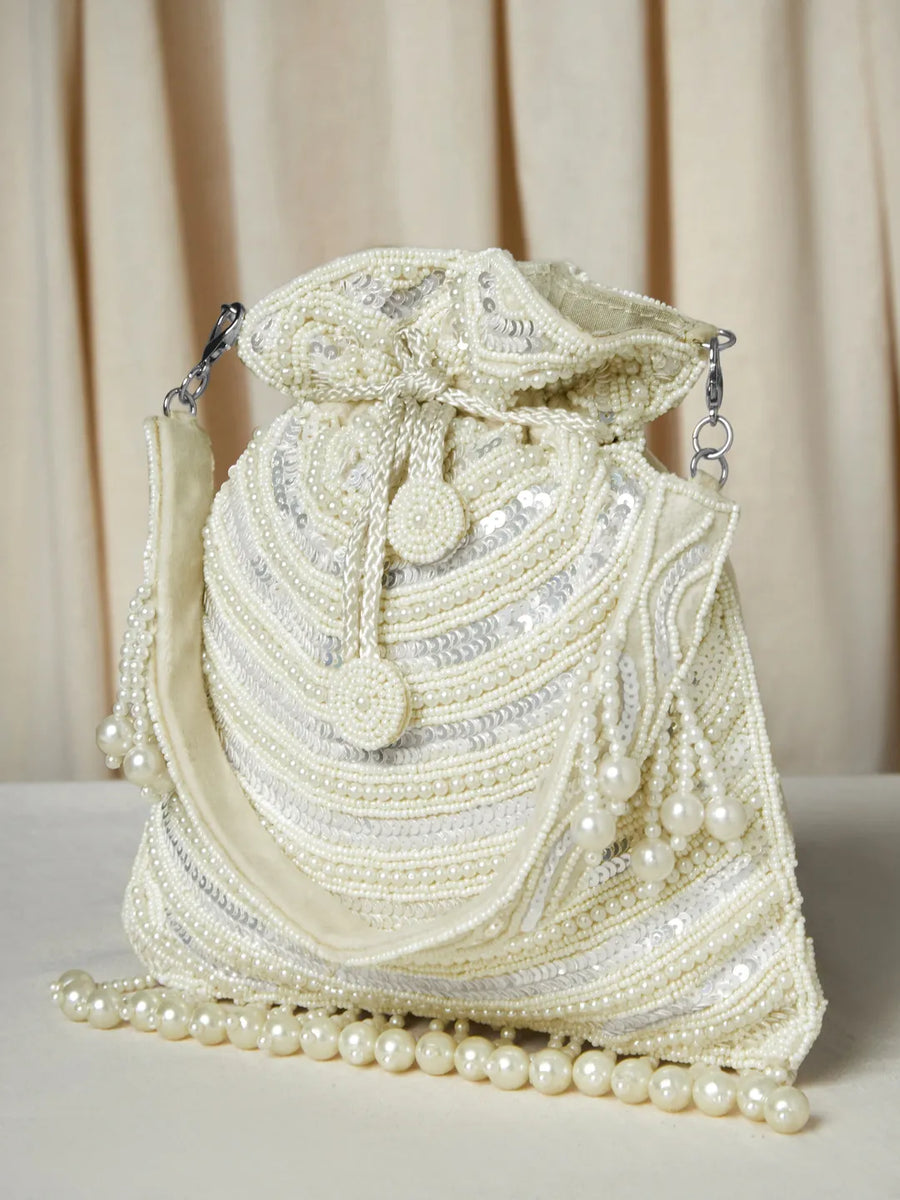 White potli bag named Handcrafted Pearl Potli Styles, featuring pearl detailing and soft fabric texture | Peora
