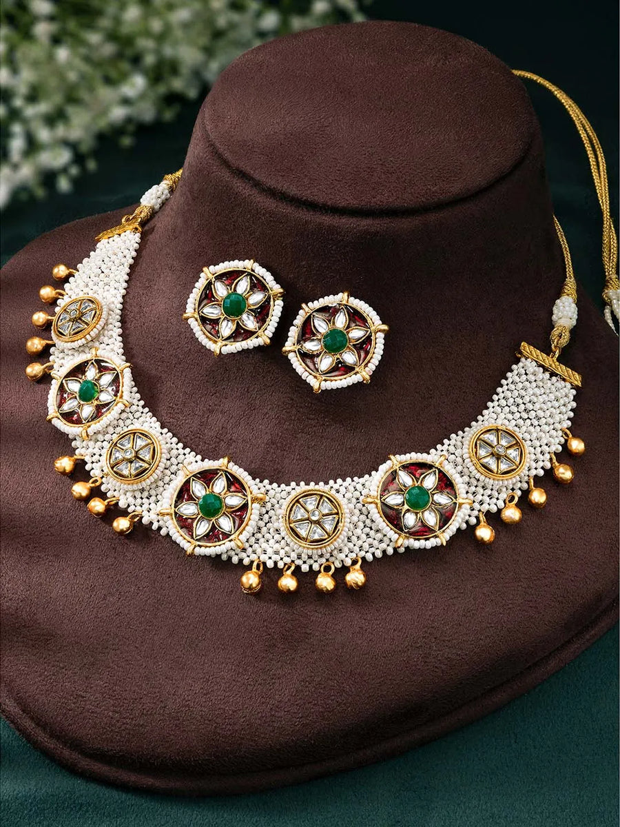 Glowing Gleaming Pearls Choker Set Gold choker necklace set with pearls, green stones, red meenakari work, and Kundan embellishments – best selling jewellery from Peora