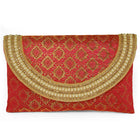 Maroon clutch bag named Twilight Gleam Foldover Clutch, featuring pearl detailing and soft fabric texture | Peora

