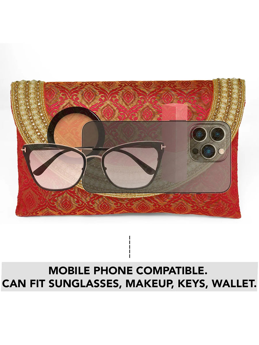 Maroon clutch bag named Twilight Gleam Foldover Clutch, featuring pearl detailing and soft fabric texture | Peora
