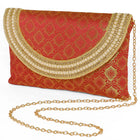 Maroon clutch bag named Twilight Gleam Foldover Clutch, featuring pearl detailing and soft fabric texture | Peora
